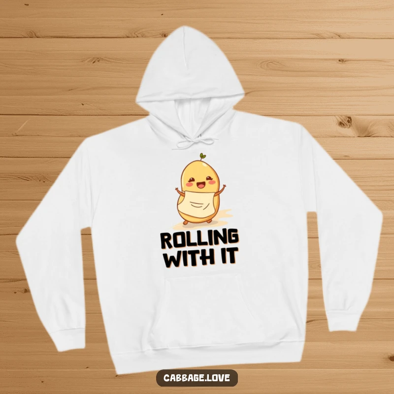 Funny hoodie shows a cheerful potato in an apron rolling down a hill, a comical and cozy apparel choice for humor lovers.